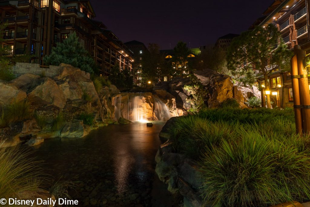 Disney's Wilderness Lodge review picture of the waterfall at night.